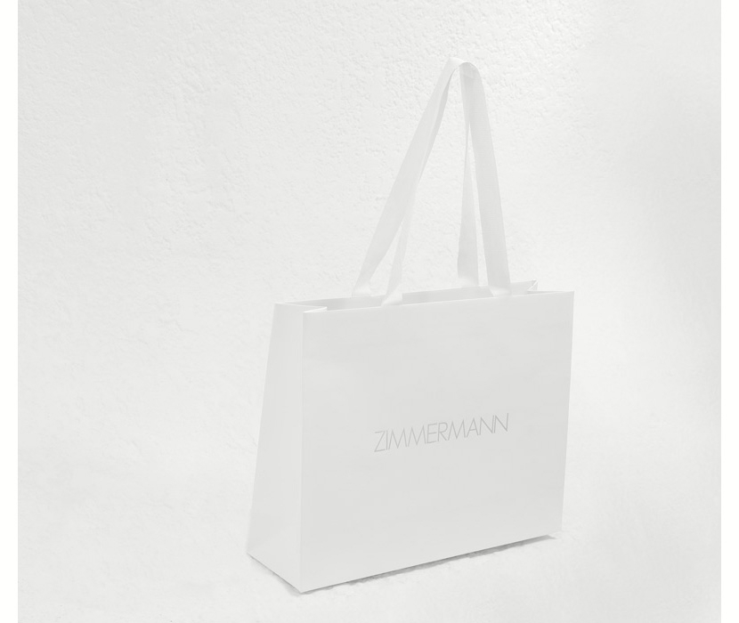 AN IMAGE OF WHITE BAG WITH ZIMMERMANN LOGO 