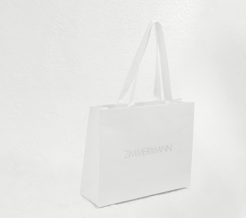 AN IMAGE OF WHITE BAG WITH ZIMMERMANN LOGO 