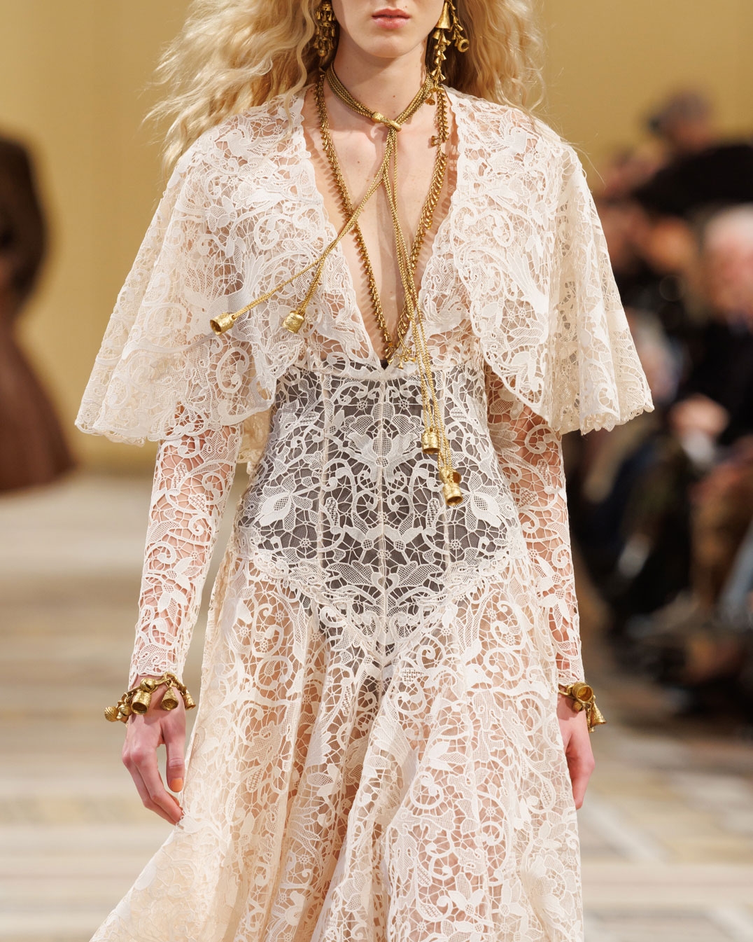 Look 21: Memento Bird Lace Dress in Cream, Whimsy Chandeliers in Antique Gold, Whimsy Single Earcuff in Antique Gold, Whimsy Charm Pendant in Antique Gold, Whimsy Necklace in Antique Gold, Whimsy Charm Bracelet in Antique Gold and Helix High Boot 