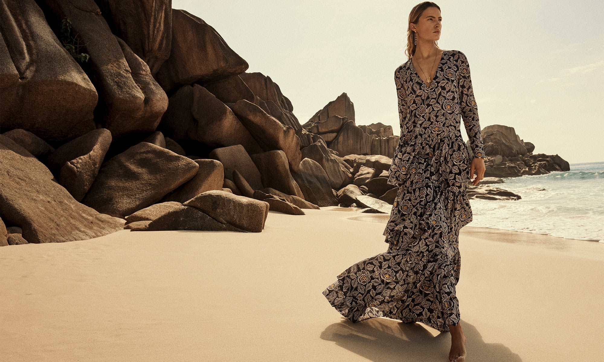 Model wears the Ottie Tiered Midi Dress in Black Floral, ZIMMERMANN Midnight Earrings in Gold, ZIMMERMANN Natura Pendant in Gold/Agate, ZIMMERMANN Bloom Band Ring in Gold/Green 