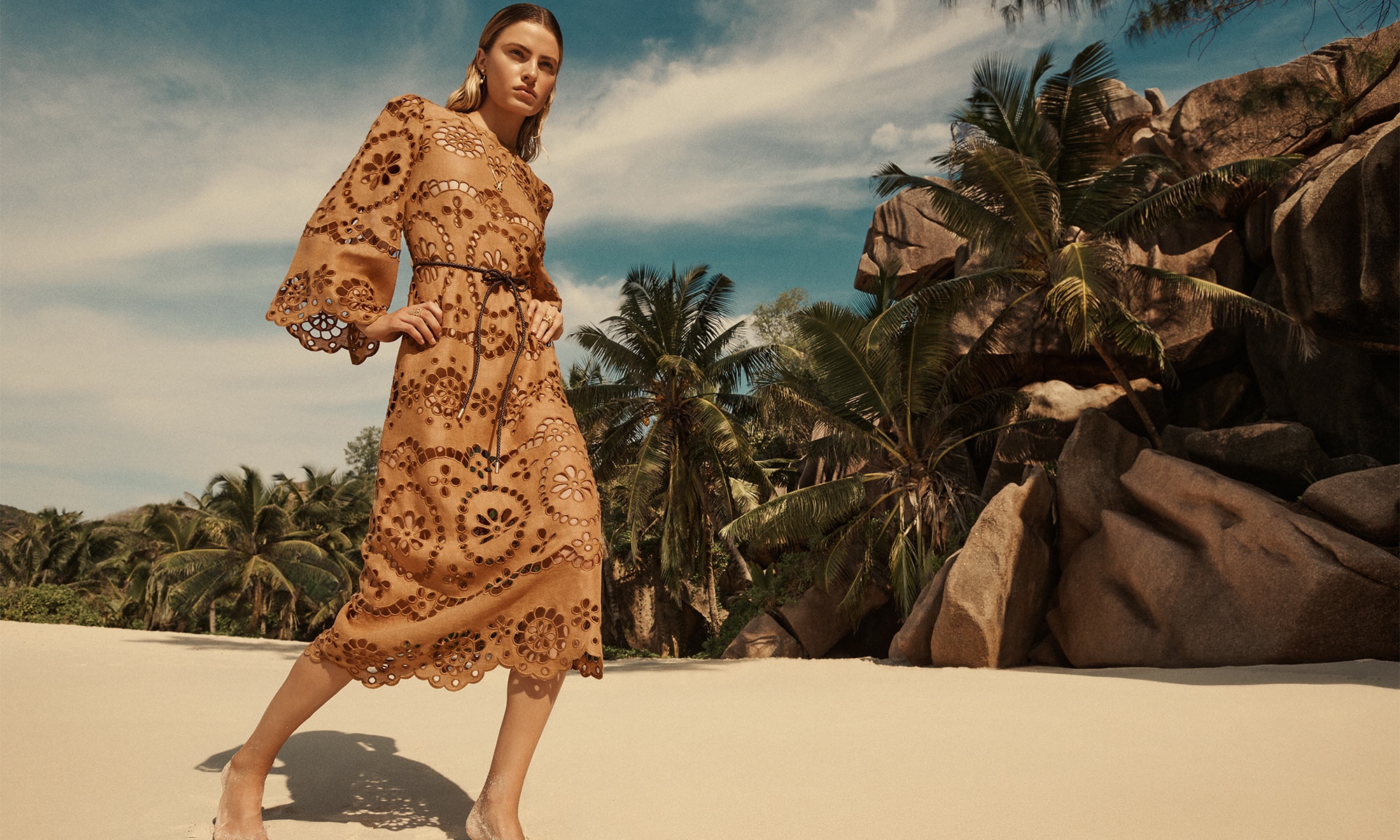 Model wears the Pop Embroidery Midi Dress in Tan, ZIMMERMANN Radiant Ear Jacket in Gold, ZIMMERMANN Natura Pendant in Gold/Agate, ZIMMERMANN Laurel Band Ring in Gold, ZIMMERMANN Bloom Ring in Gold Blush 
