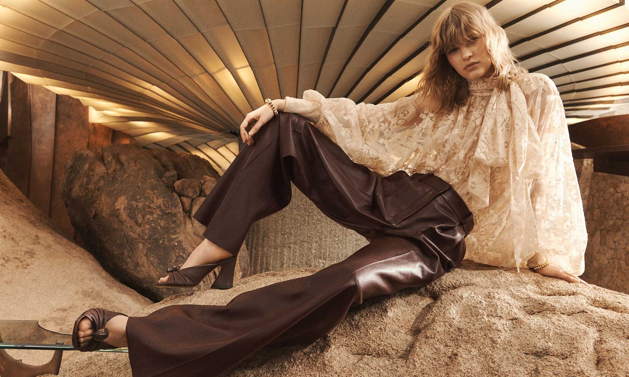 Model wears the Illustration Lace Blouse in Light Tea, Illustration Leather Pant in Mahogany, Zimmermann Deco Cuff in Gold and Zimmermann Gleam Mule 85 in Bordeaux 