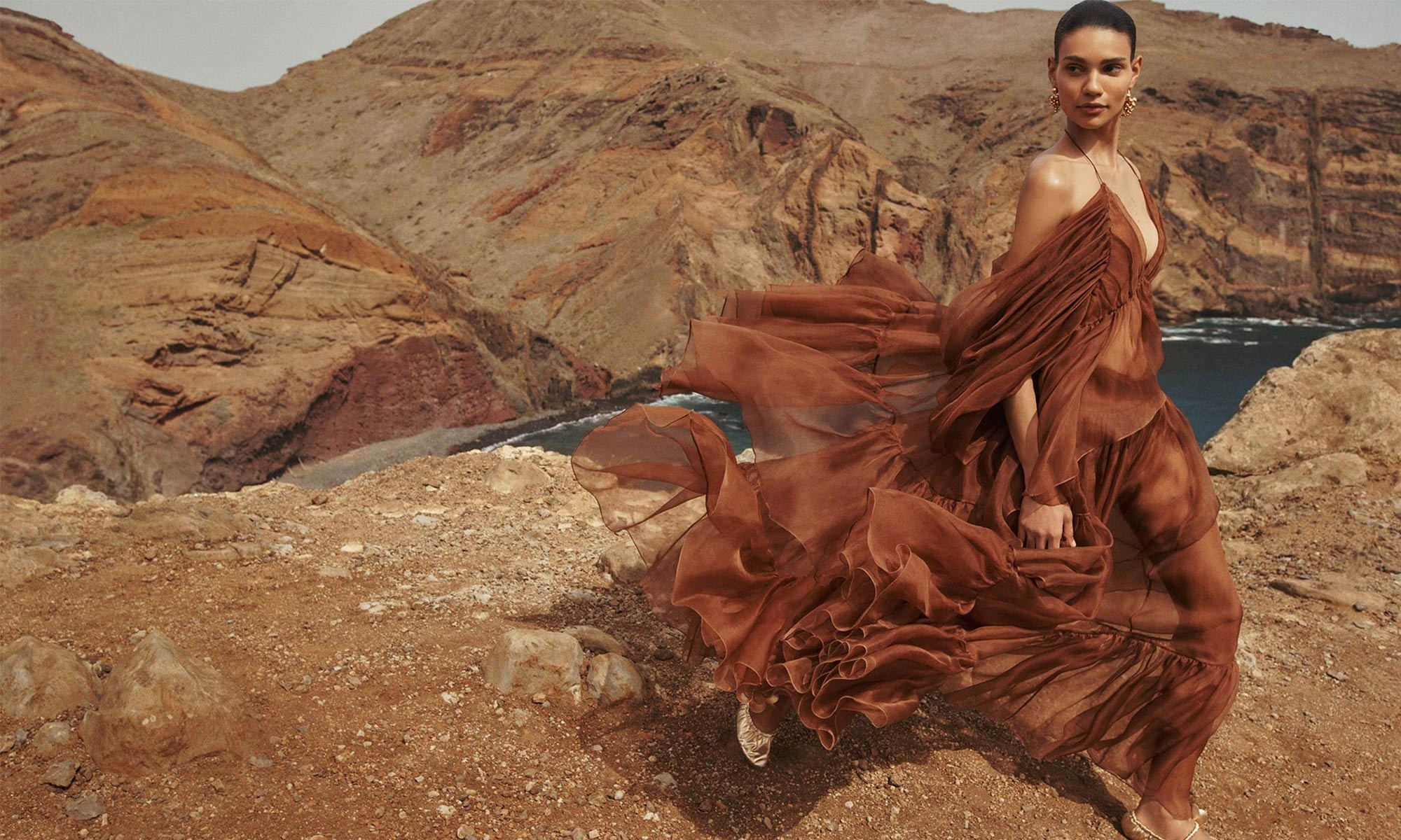 Model wears the Natura Gathered Top in Toffee, Natura Gathered Skirt in Toffee, Zimmermann Orb Earrings in Gold and Zimmermann Orchid Ballerina in Gold 