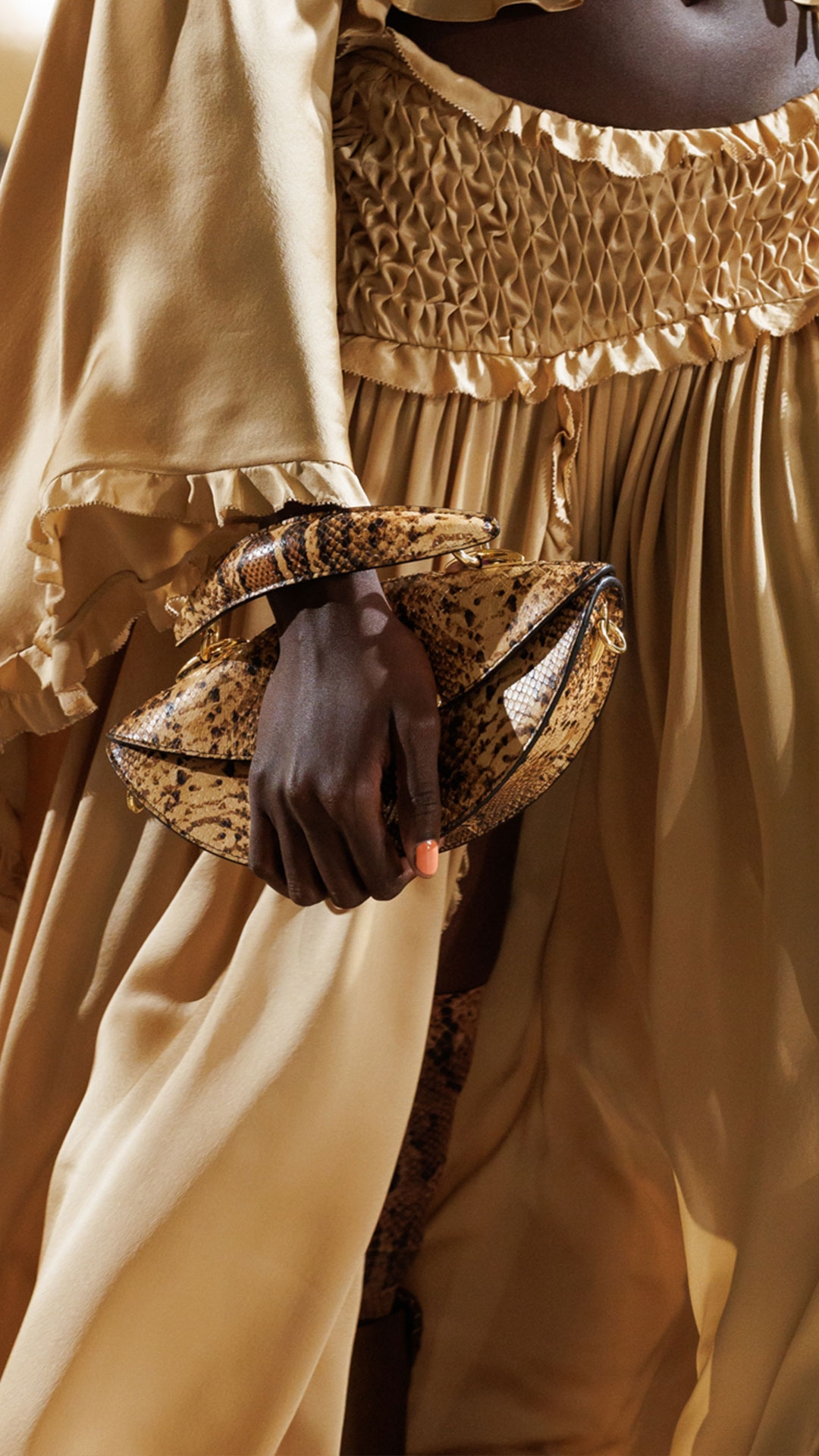 Look 45: Hypnotic Smocked Satin Bodice in Gold, Hypnotic Satin Maxi Skirt in Gold, Whimsy Chandeliers in Antique Gold, Helix High Boot in Moss and Wavelength Top Handle in Toffee 