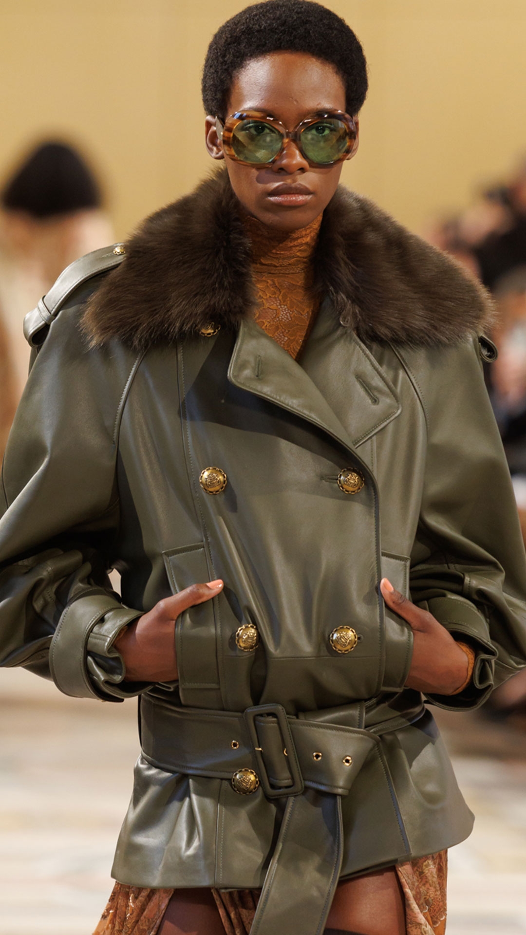Look 27: Hypnotic Leather Short Trench in Olive, High Neck Bodysuit in Caramel, Memento Burnout Maxi Skirt in Caramel Paisley, Helix High Boot in Chocolate and Miranda Oversize in Green 