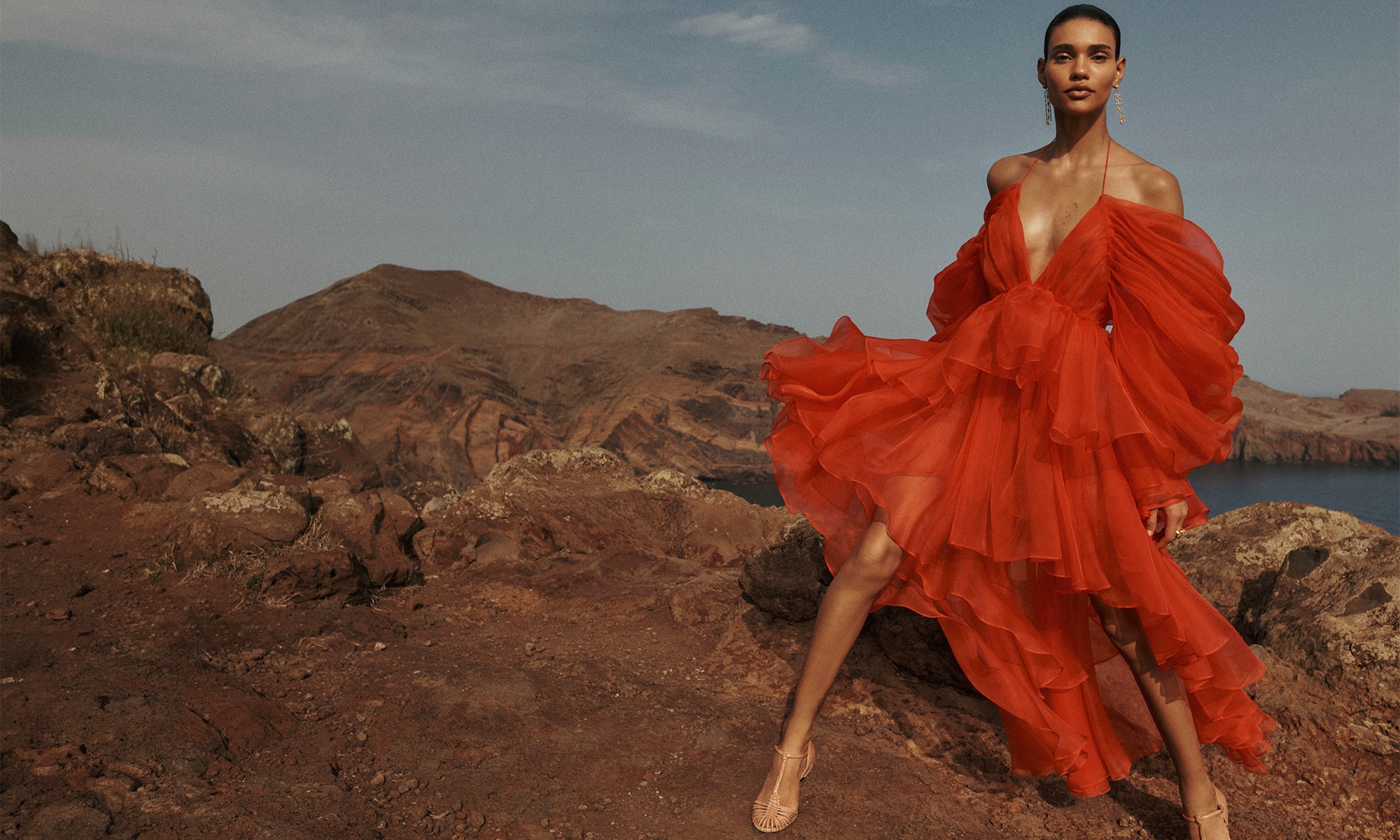 Model wears the Natura Gathered Mini in Tomato, Zimmermann Celesta Ballerina in Peach, Zimmermann Midnight Earrings in Gold and Zimmermann Bloom Ring in Gold/Blush 