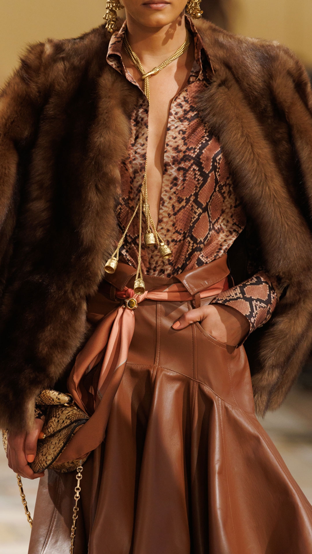 Look 22: Hypnotic Tip Shearling Jacket in Toffee, Hypnotic Satin Shirt in Toffee Snake, Hypnotic Leather Midi Skirt in Tan, Whimsy Chandeliers, Whimsy Charm Pendant, Cocktail Ring, Printed Silk Square 90, Helix Loafer, Miranda Oversize 