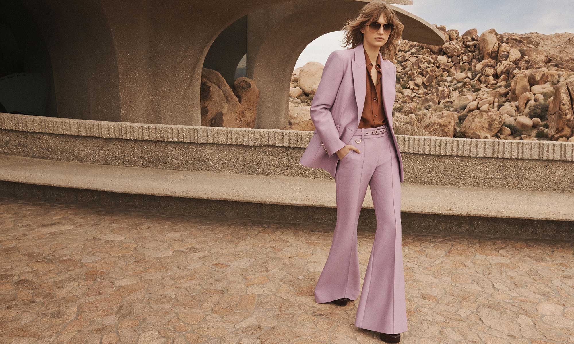 Model wears the Illustration Tailored Jacket in Lilac, Illustration Relaxed Shirt in Cognac, Illustration Wide Leg Pant in Lilac, Zimmermann Eliot Pump 100 in Bordeaux and Zimmermann Gleam Aviator in Caramel 