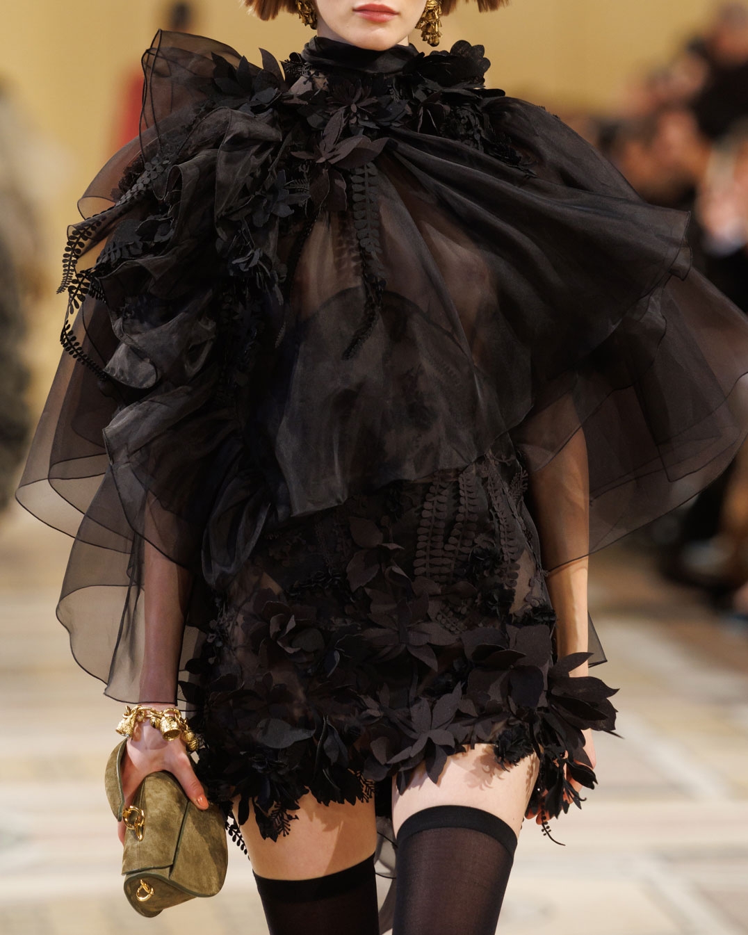 Look 46: Hypnotic Applique Mini Dress in Black, Whimsy Chandeliers in Antique Gold, Whimsy Charm Bracelet in Antique Gold, Helix Sandal 75 in Black and Wavelength Top Handle in Olive 