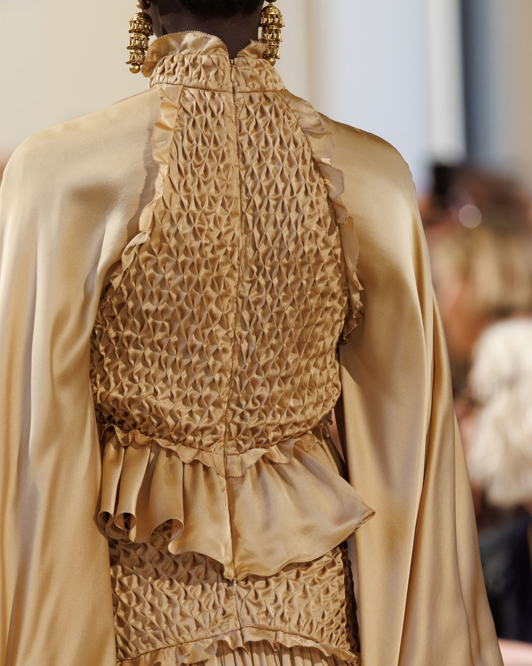 Look 45: Hypnotic Smocked Satin Bodice in Gold, Hypnotic Satin Maxi Skirt in Gold, Whimsy Chandeliers in Antique Gold, Helix High Boot in Moss and Wavelength Top Handle in Toffee 