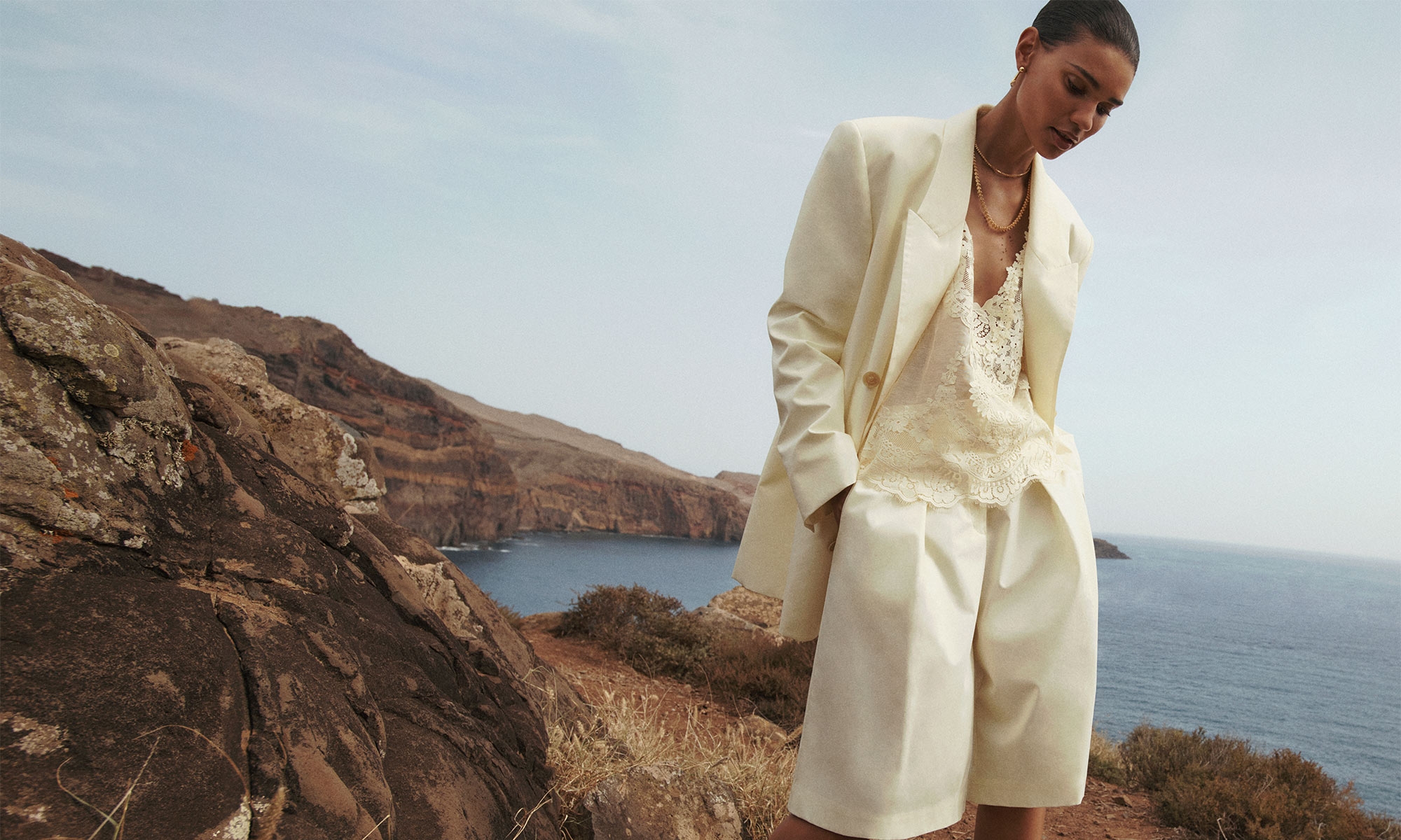 Model wears the Harmony Poplin Jacket in Lemon, Harmony Slouchy Short in Lemon, Natura Lace Patch Tank in Lemon, Zimmermann Laurel Necklace in Gold and Zimmermann Radiant Ear Jacket in Gold 