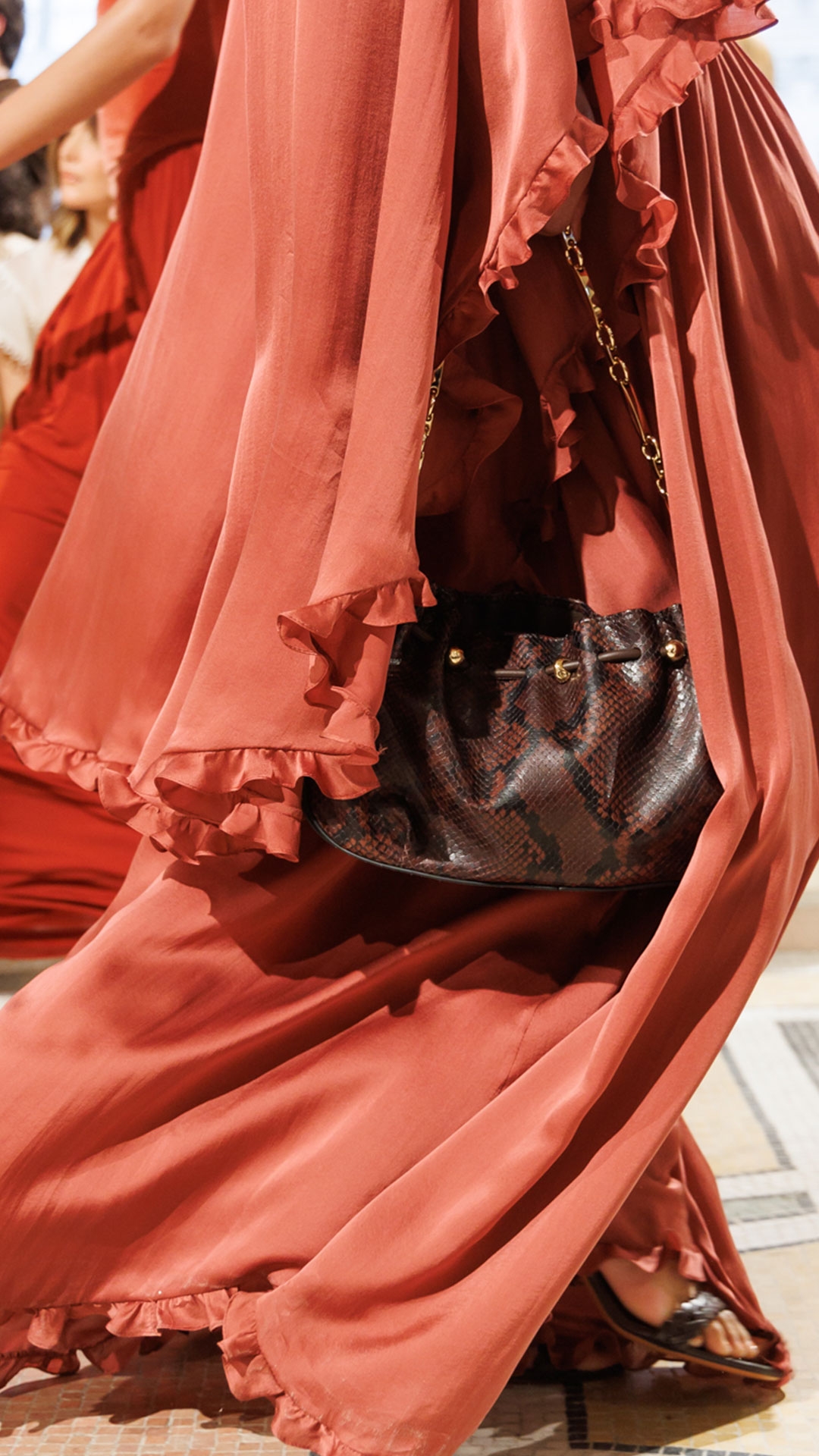 Look 43: Hypnotic Smocked Gown in Lipstick, Byron Ceramic Earrings in Gold/Burgundy, Helix Sandal 75 in Burgundy, Miranda Oversize in Pink and Halcyon Clutch in Dark Brown 
