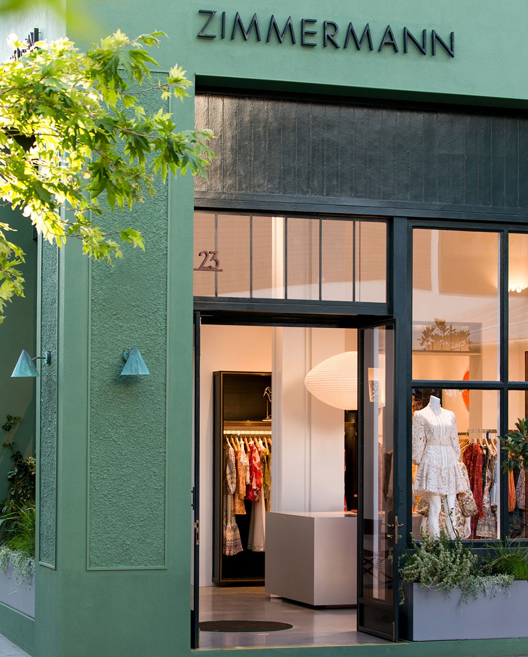 a green vase and foliage display in store at Scottsdale Arizona store 