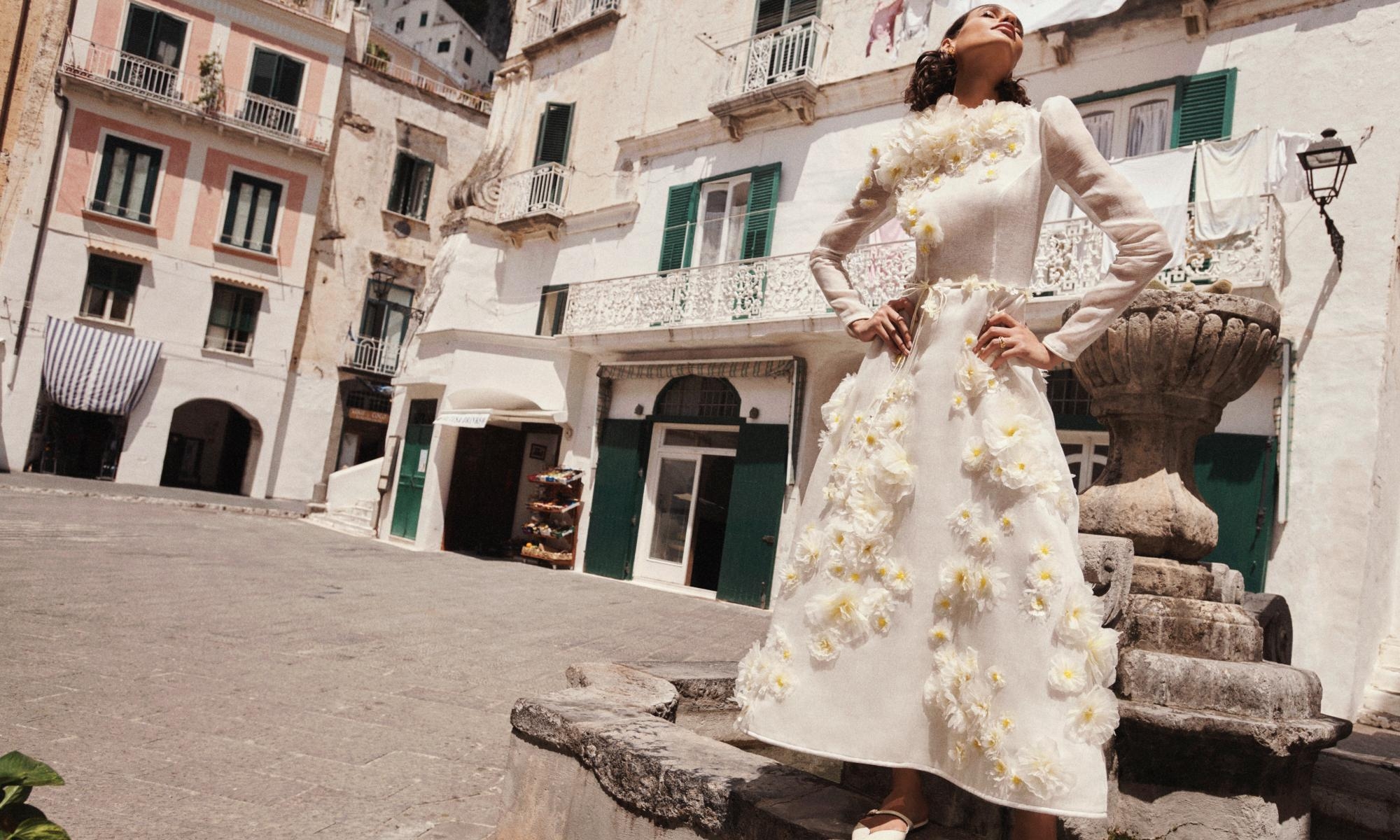 Model wears the Matchmaker Daisy Midi Dress in Ivory, Zimmermann Bloom Large Studs in Gold/Pearl, Zimmemorabilia Band Ring in Gold/Green and Aura Mule in Macadamia 