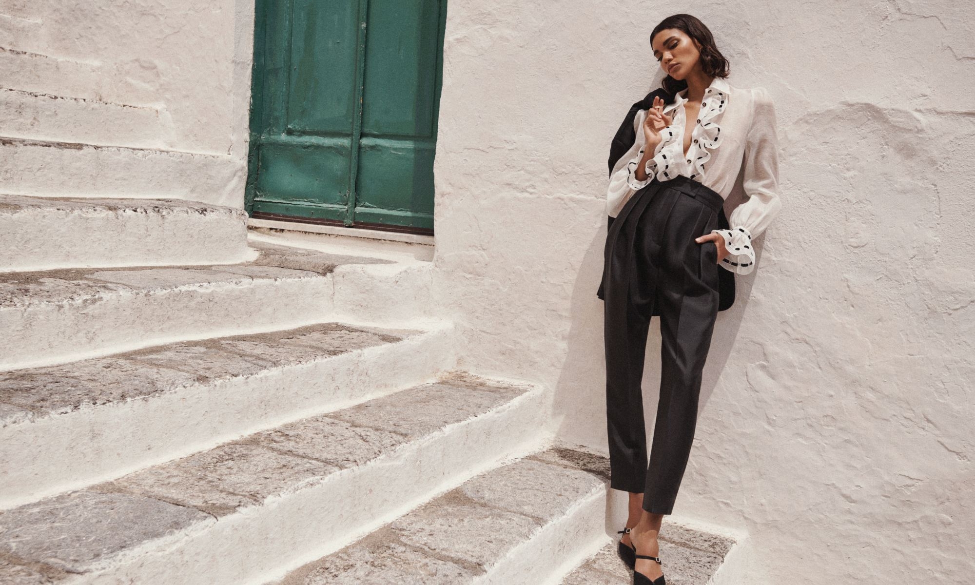 Model wears the Matchmaker Tuxedo Body Shirt in Ivory, Matchmaker Pleat Front Pant in Black, Matchmaker Tuxedo Jacket in Black, Zimmemorabilia Stone Hoops in Gold/Lapis and Aura Mule 65 in Black 