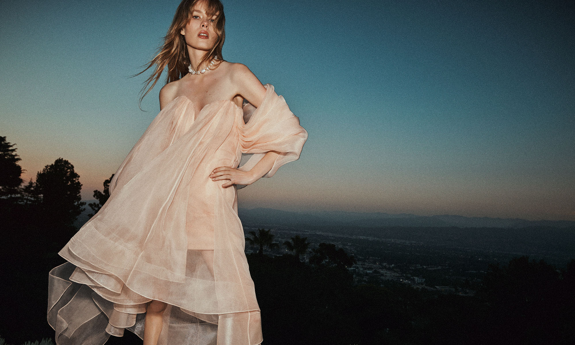 Model wears the Crush Strapless Mini Dress in Peach, Zimmermann Wish Necklace in Gold/Pearl and Zimmermann Tux Mule 65 in Black 