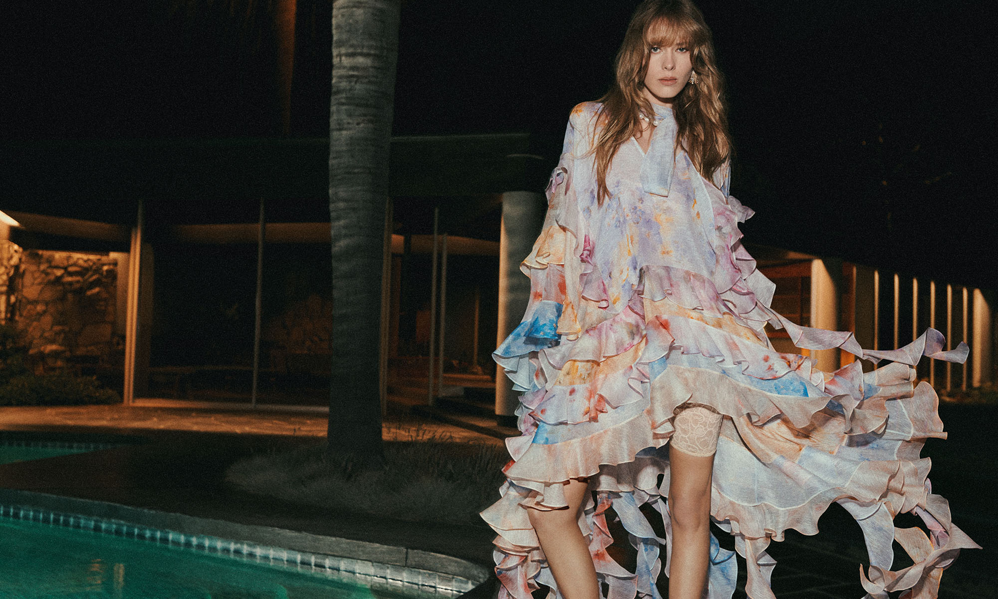Model wears the Crush Spliced Ruffle Dress in Spliced Floral, Zimmermann Wish Necklace in Gold/Pearl, Zimmermann Nova Fringe Studs in Gold and Zimmermann Tux Mule in Gold 