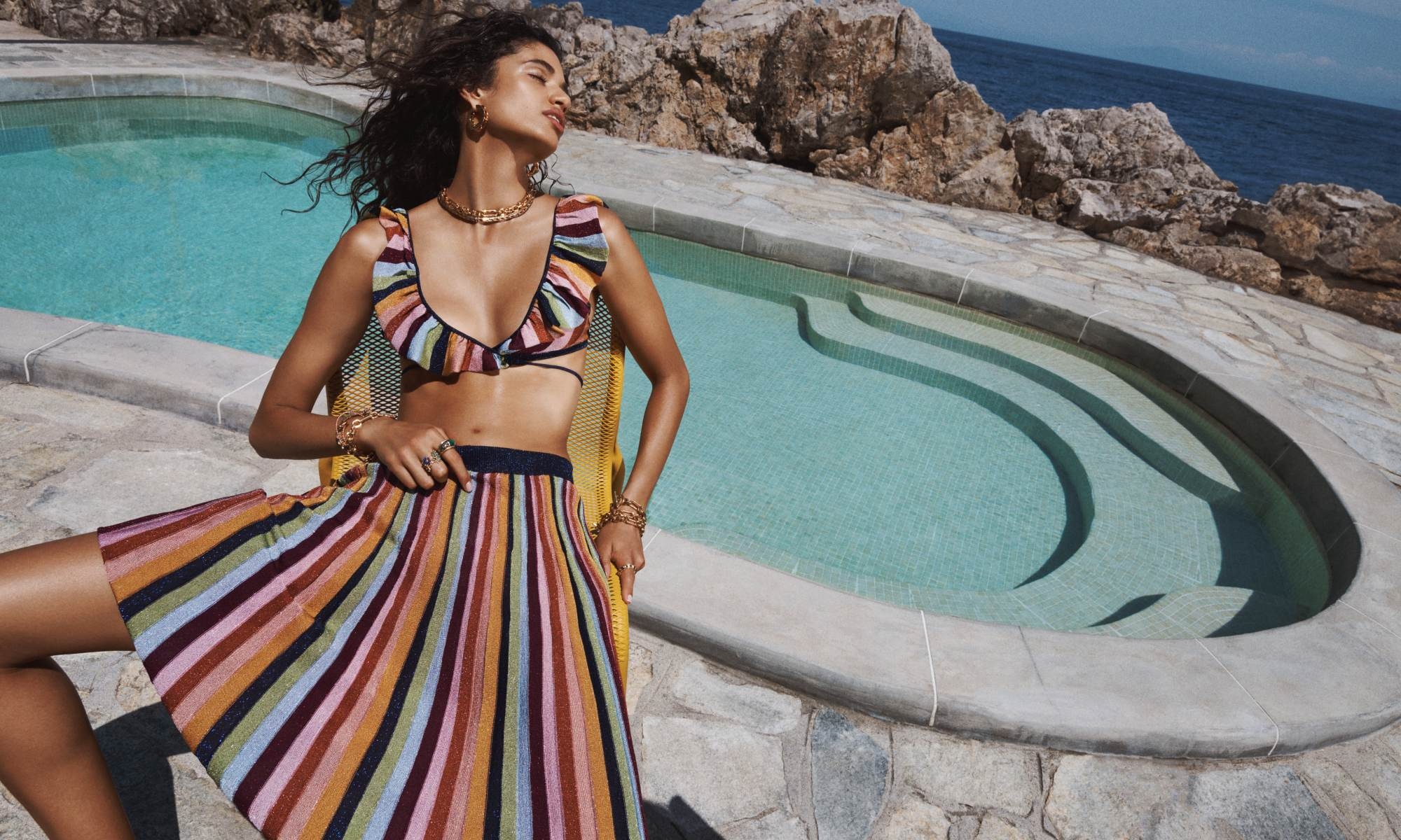 Model wears the Alight Lurex Knit Wrap Bikini in Lurex Multi Stripe and Alight Lurex Stripe Midi Skirt in Lurex Multi 