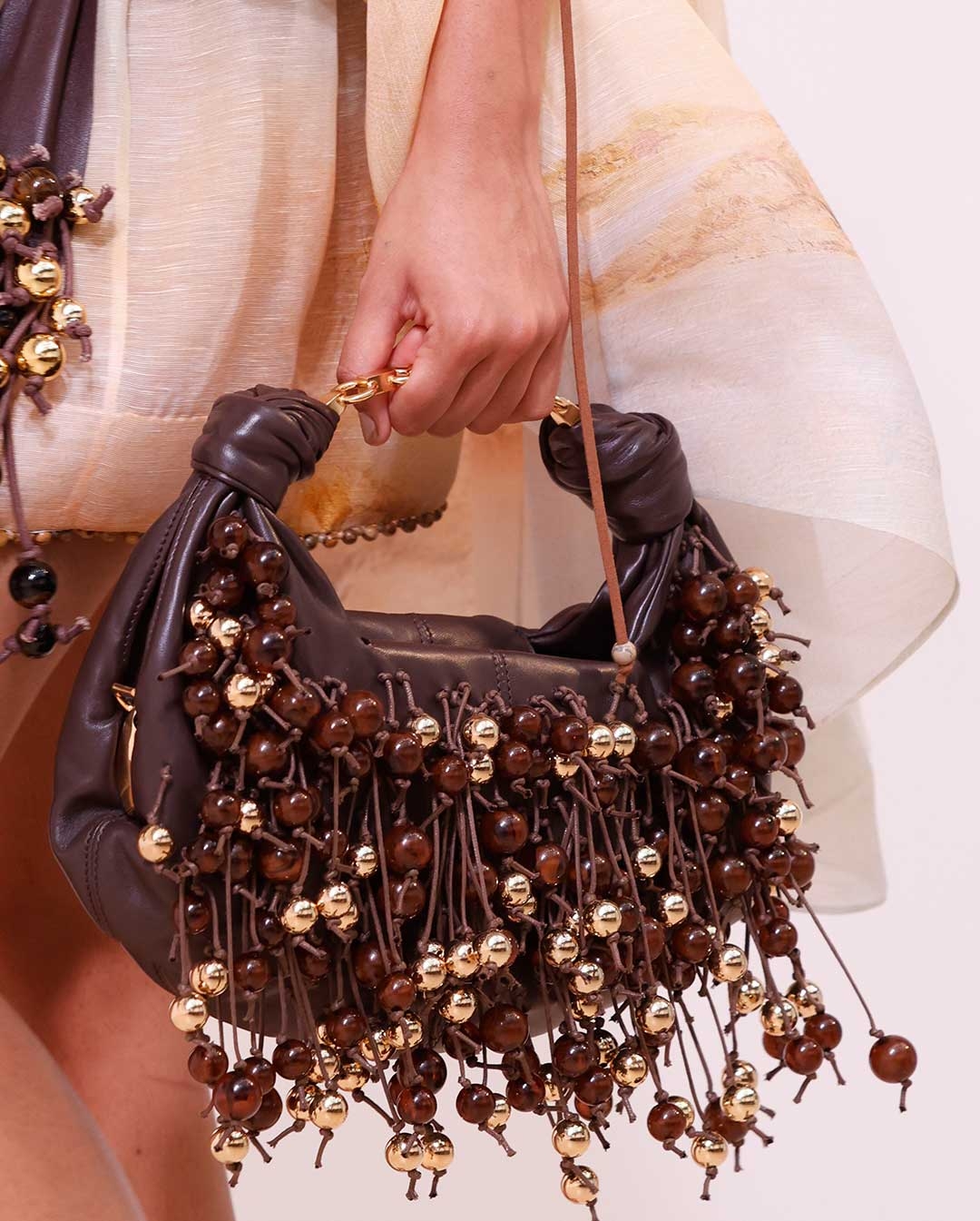 Look 16: Balance Plunge Mini Dress in Yellow Seascape, Ore Zebra Hoops in Gold/Black, Mellow Pearl Beaded Necklace in Gold/Multi, Ore Lariat Necklace in Gold/Black, Foam Embellished Wrap Belt in Coffee, Foam Bag in Coffee and Wild Wedge 95 in Espresso 