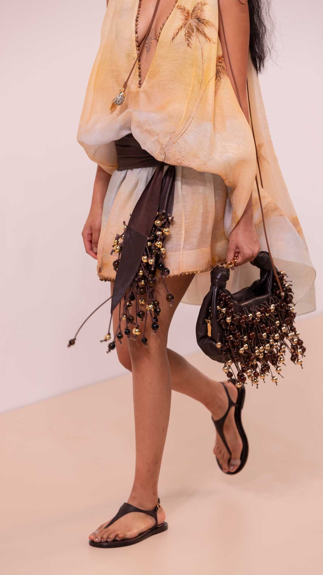 Look 16: Balance Plunge Mini Dress in Yellow Seascape, Ore Zebra Hoops in Gold/Black, Mellow Pearl Beaded Necklace in Gold/Multi, Ore Lariat Necklace in Gold/Black, Foam Embellished Wrap Belt in Coffee, Foam Bag in Coffee and Wild Wedge 95 in Espresso 