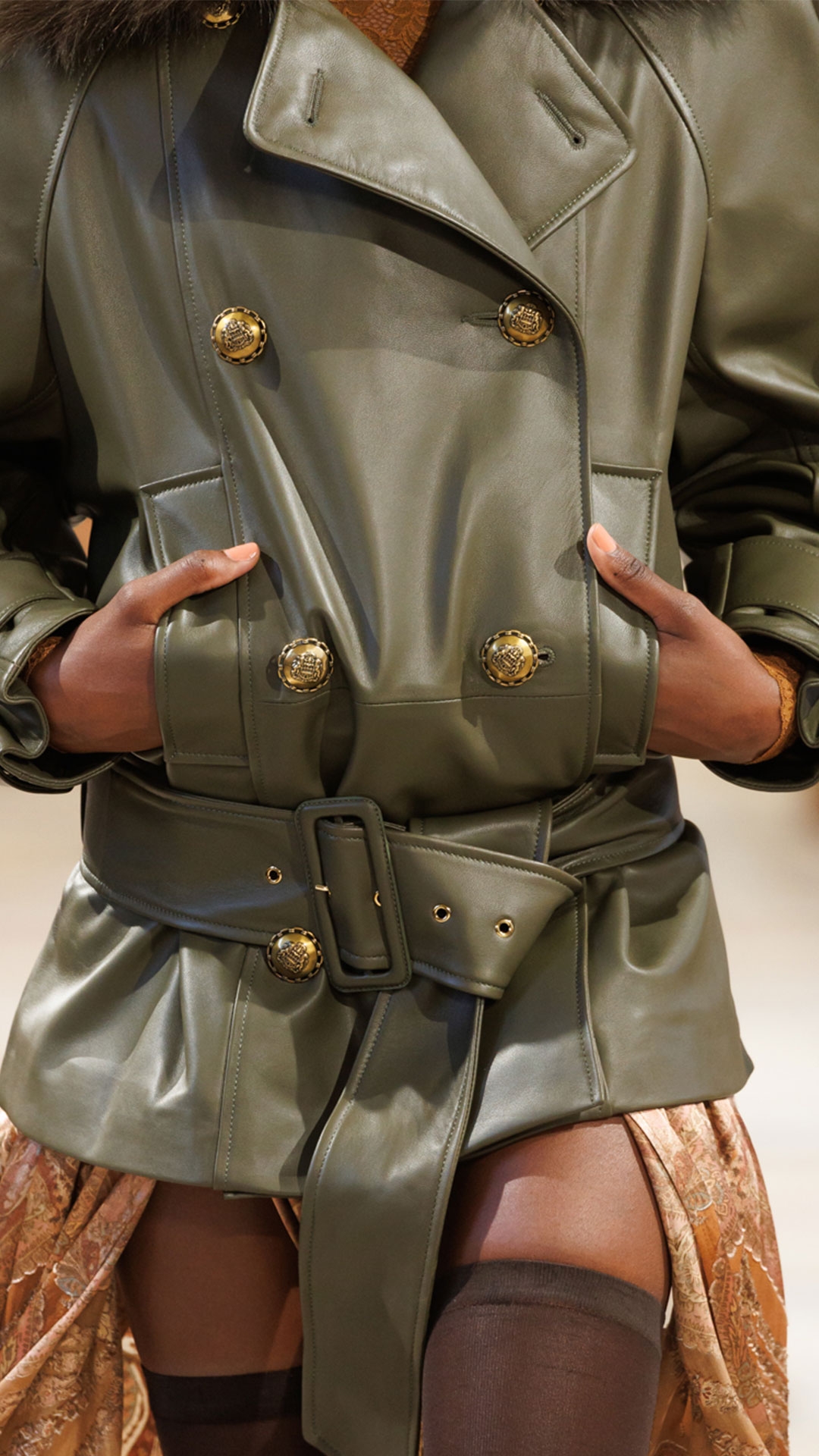 Look 27: Hypnotic Leather Short Trench in Olive, High Neck Bodysuit in Caramel, Memento Burnout Maxi Skirt in Caramel Paisley, Helix High Boot in Chocolate and Miranda Oversize in Green 