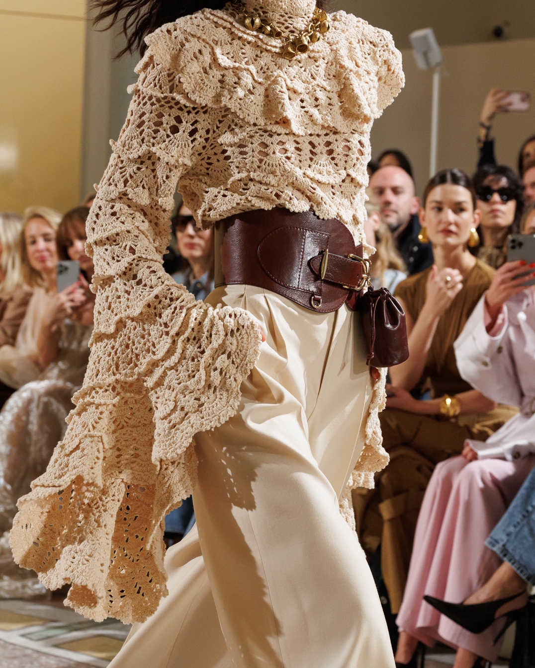 Look 18: Hypnotic Hand Crochet Sweater in Chalk, Hypnotic Straight Leg Pant in Cream, Helix Belt 100 in Chestnut, Whimsy Chandeliers in Antique Gold, Whimsy Charm Necklace in Antique Gold and Helix Sandal 75 in Wheat 