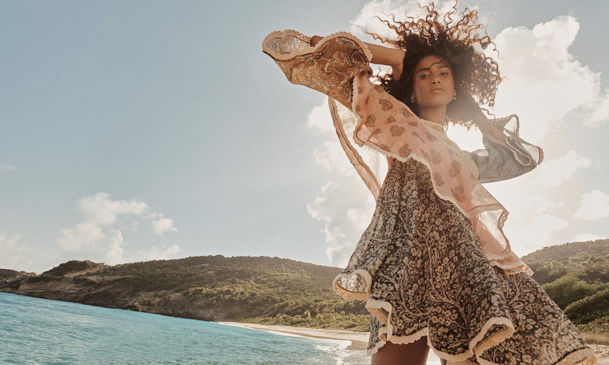 Model is wearing the Tallow Asymmetric Mini Dress in Spliced and the Zimmermann Adore Drop Earrings in Gold 