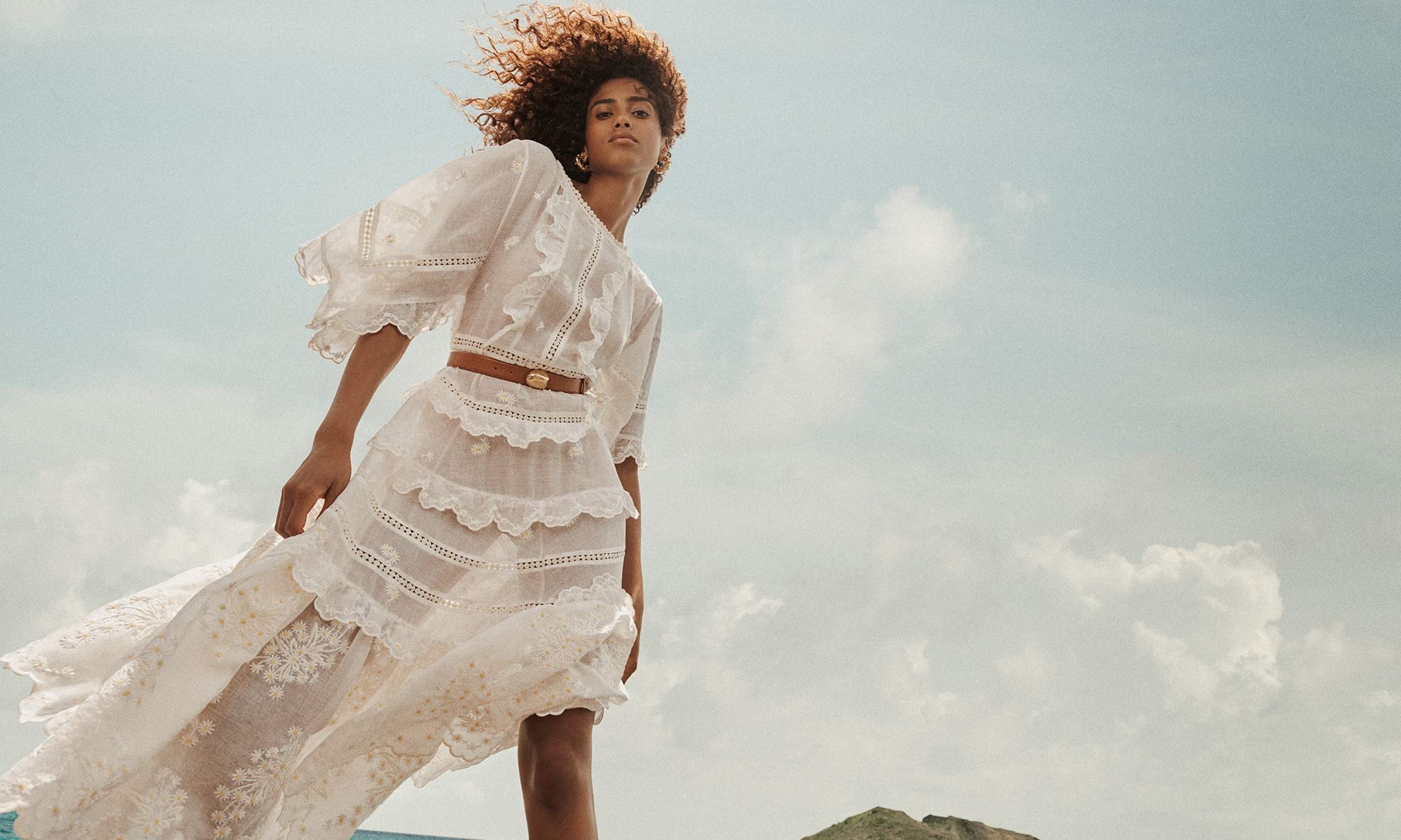 Model wears the Acacia Embroidered Midi Dress in Ivory, Zimmermann Wish Hoops in Gold and Zimmermann Gleam Belt 30 in Tan 