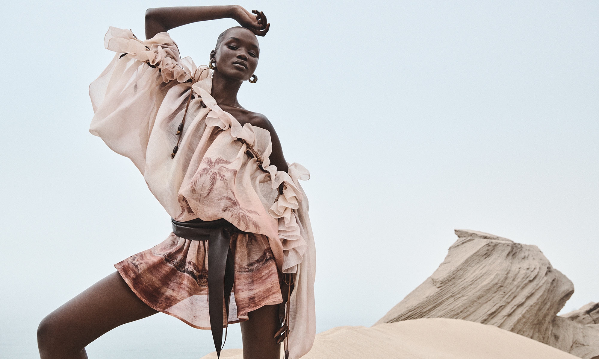 Model wears the Illuminate Ruffle Mini Dress in Rust Seascape, Foam Wrap Belt in Coffee and Ore Ceramic Hoops in Gold/Ceramic 