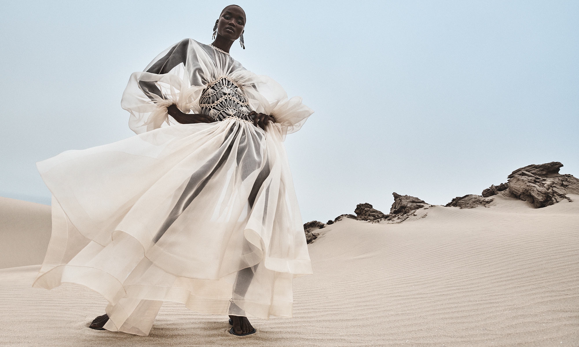 Model wears the Illuminate Macrame Gown in Cream, Ore Chandeliers in Gold/Copper and Wild Sandal in Espresso 