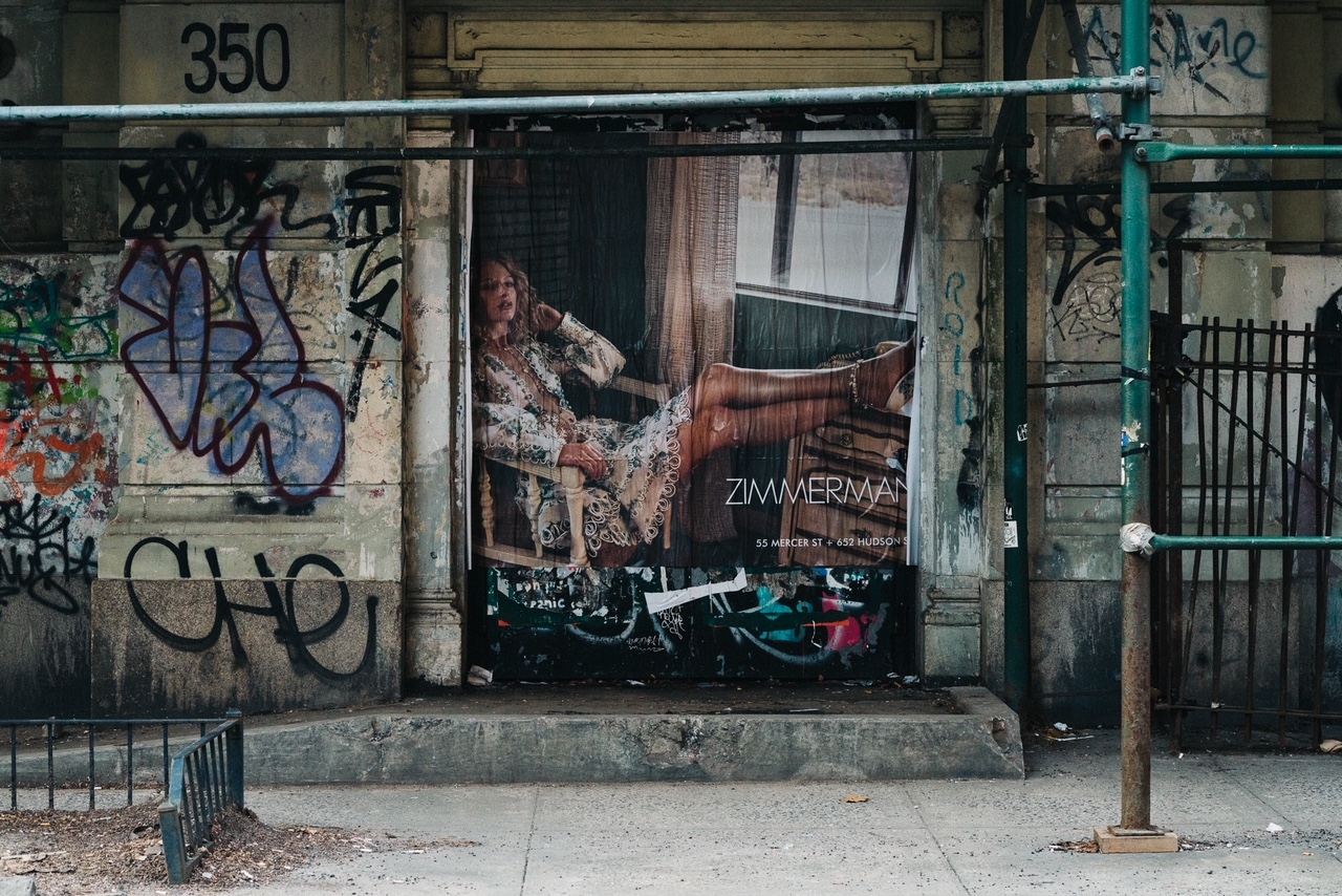 A large Zimmermann campaign image surrounded by graffiti on a New York street