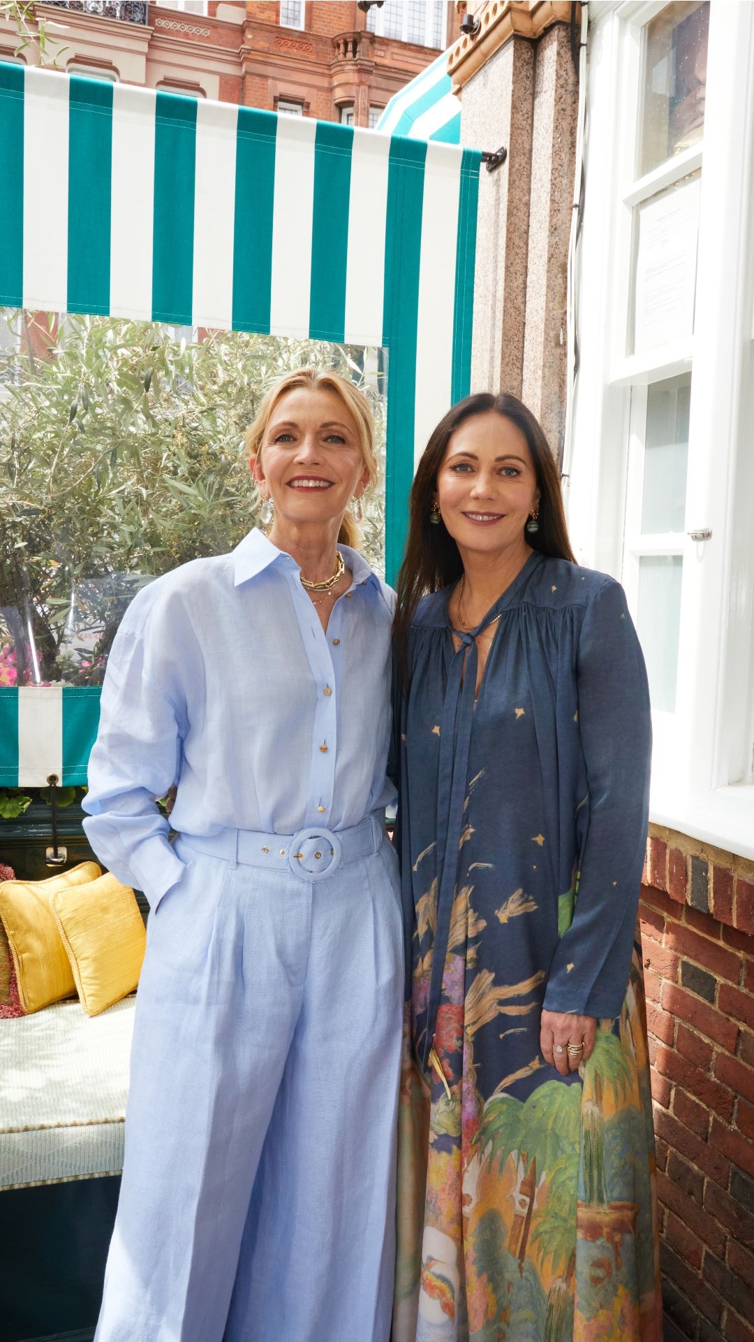 Simone wears the Tama Button Up Shirt and Tama Wide Leg Pant. Nicky wears the Lyrical Sheath Dress from the upcoming Fall 2023 collection. 