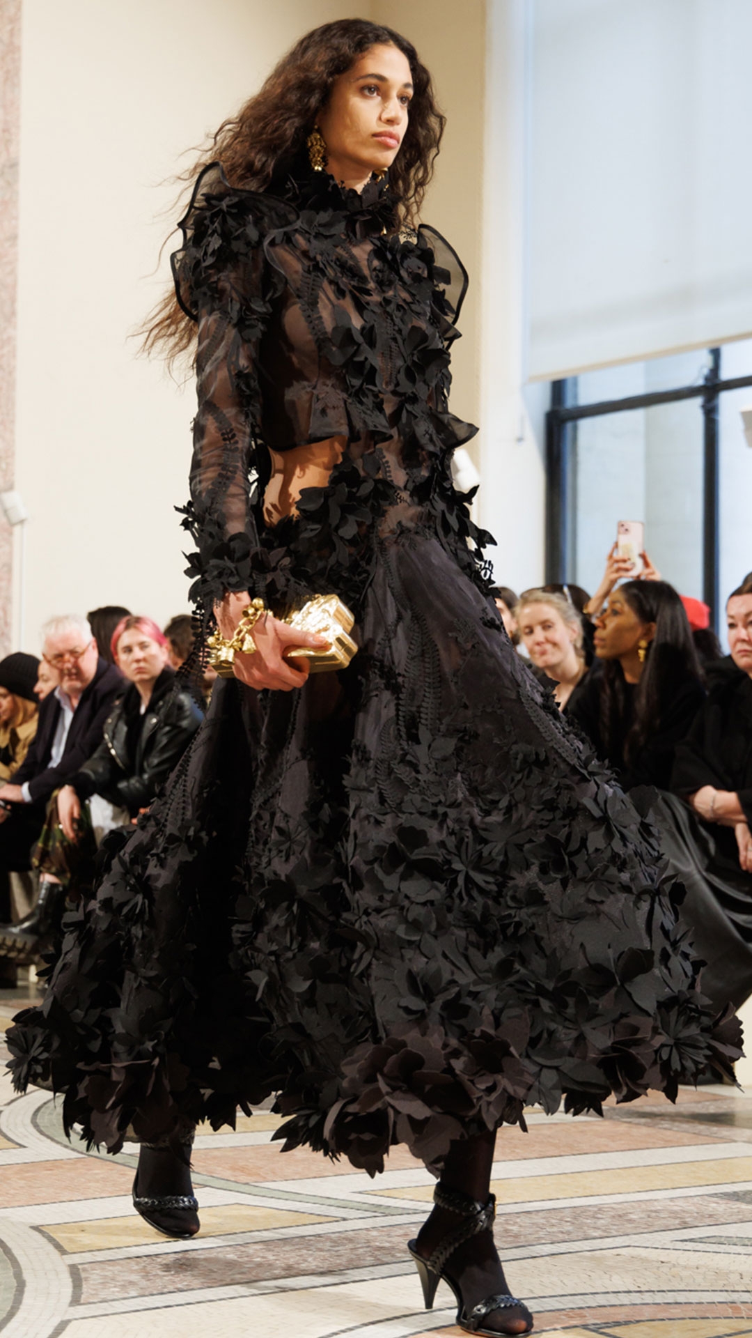 Look 49: Hypnotic Applique Dress in Black, Whimsy Chandeliers in Antique Gold, Whimsy Single Earcuff in Antique Gold, Whimsy Charm Bracelet in Antique Gold, Helix Sandal 75 in Black and Radiate Clutch in Gold 