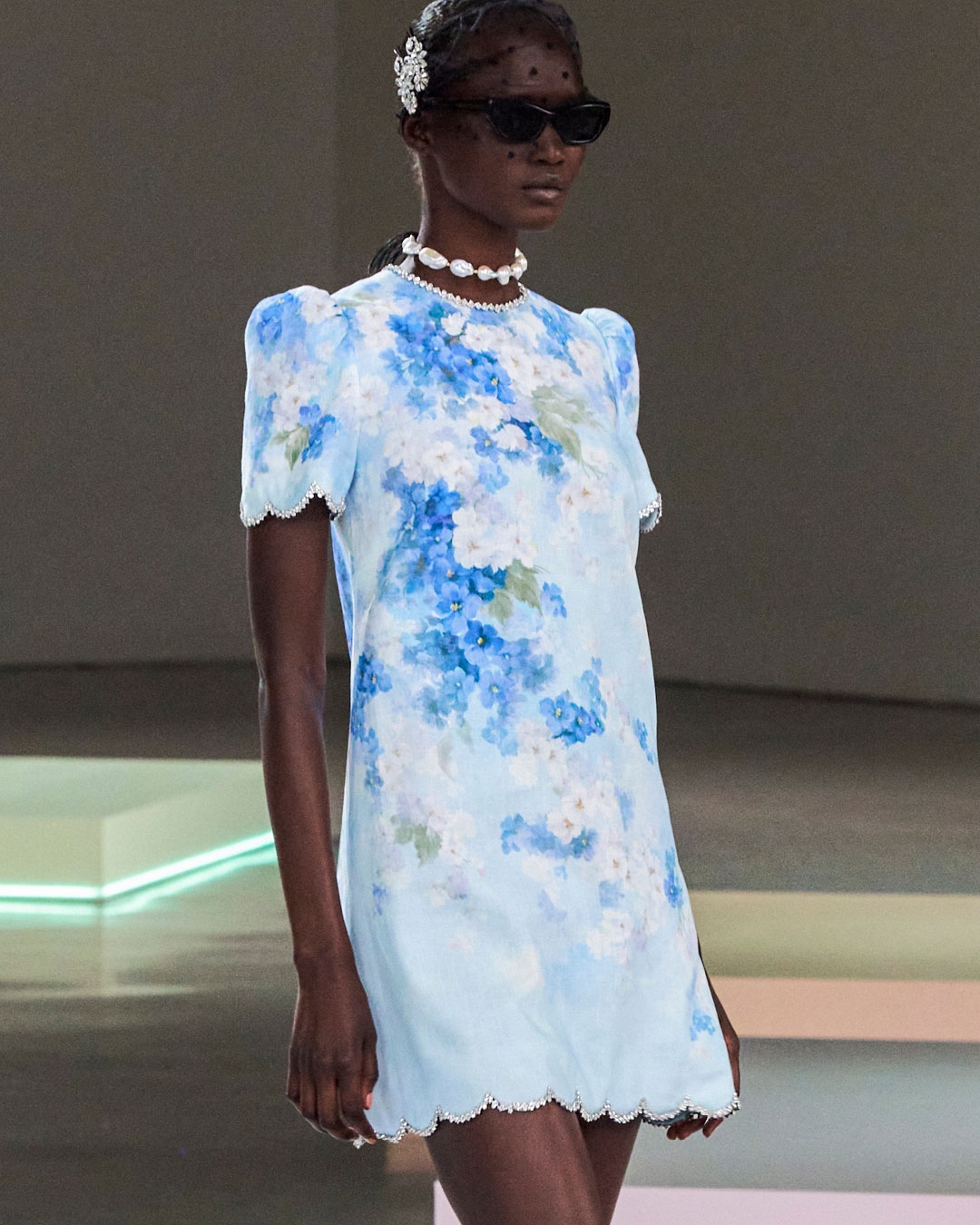  LOOK 19: CRUSH SCALLOPED SHIFT DRESS IN BLUE FLORAL, ZIMMERMANN WISH NECKLACE IN GOLD/PEARL BLACK CORD, EMBELLISHED HAIR PIN SET IN SILVER, VEIL HEADBAND IN BLACK, ZIMMERMANN TUX MULE IN BLACK AND ZIMMERMANN LIV SQUARE IN BLACK 