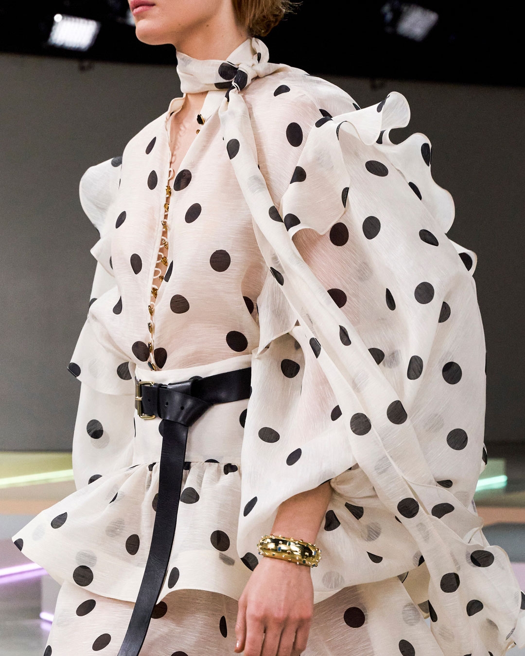  LOOK 32: CRUSH TIE NECK RUFFLE BLOUSE IN CREAM/BLACK DOT, CRUSH HIGH-LOW TIERED SKIRT IN CREAM/BLACK DOT, ZIMMERMANN WISH CUFF IN GOLD, LONG BELT 40 IN BLACK, ZIMMERMANN TUX MULE IN BLACK AND ZIMMERMANN SANDY AVIATOR IN BLACK 