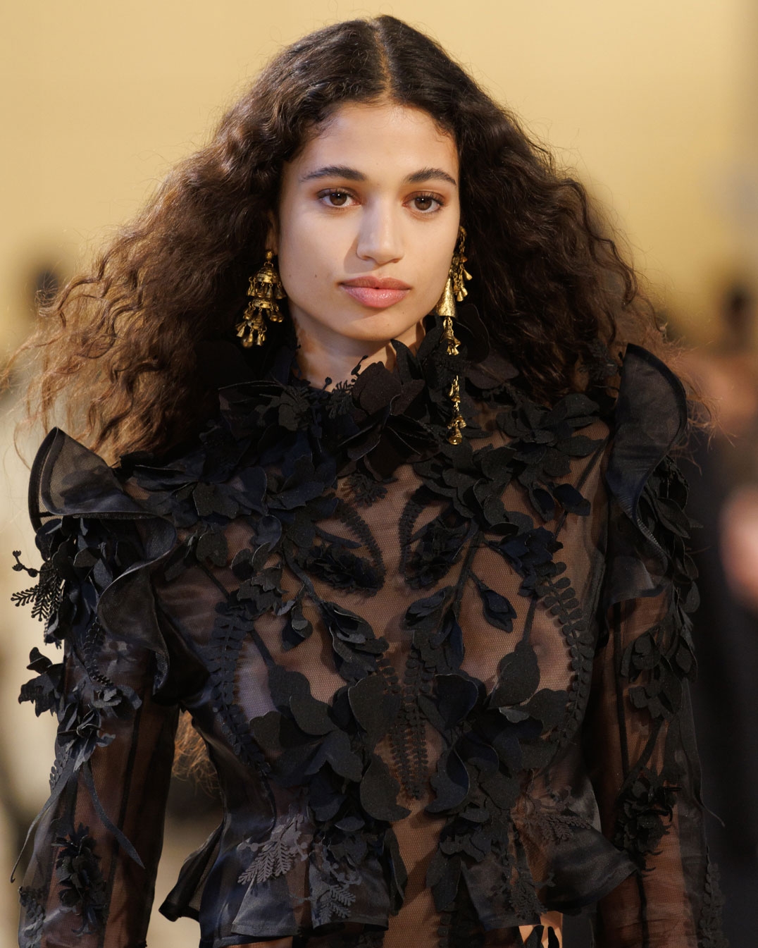 Look 49: Hypnotic Applique Dress in Black, Whimsy Chandeliers in Antique Gold, Whimsy Single Earcuff in Antique Gold, Whimsy Charm Bracelet in Antique Gold, Helix Sandal 75 in Black and Radiate Clutch in Gold 